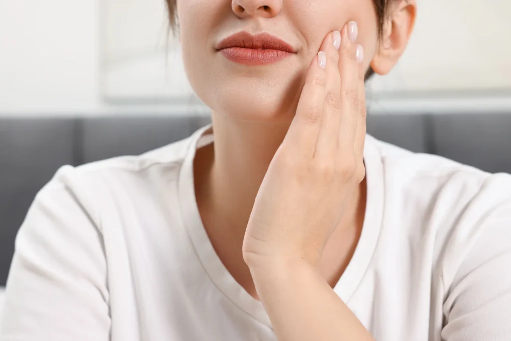 Woman touching the side of her jaw