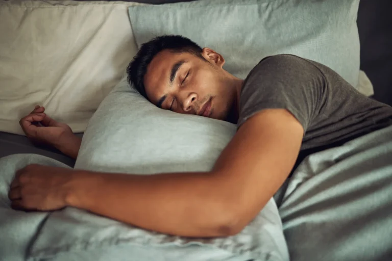 Man sleeping on his side with his head on a pillow